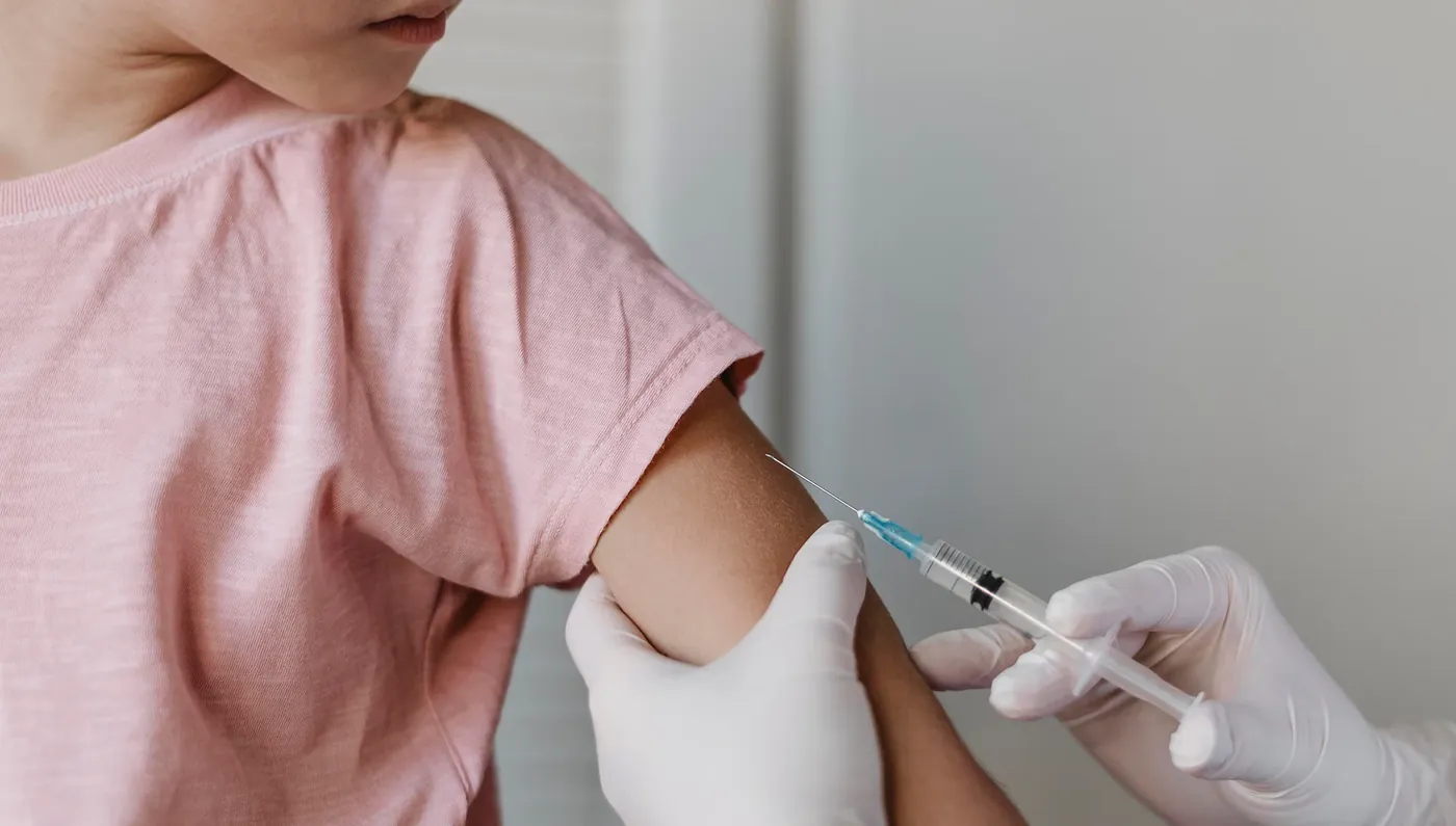 A child receiving a vaccination in the arm